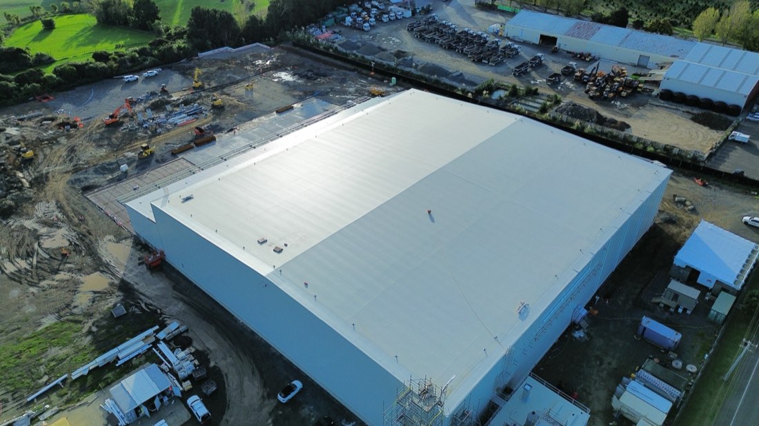 White TPO membrane roof on a large industrial building in Auckland, seen from above